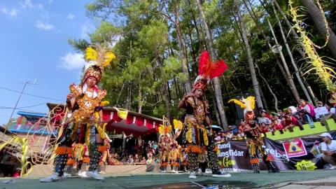Static low angle view of dancers performing dayakan dance, outdoor scene Stock Footage 247330875