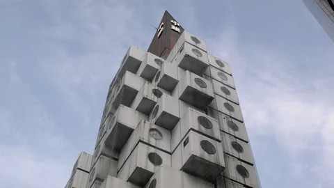 Static low angle view looking up to the top of the Nakagin Capsule Tower Stock Footage 104788599