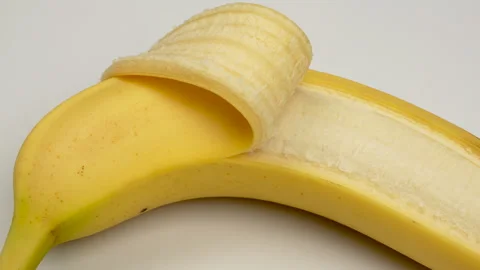 Static Macro Close Up Partially Peeled Yellow Banana Texture 4K Stock Footage 322142760