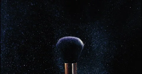 Static makeup brush with small particles of blue cosmetics flying around brush Stock Footage 245274227