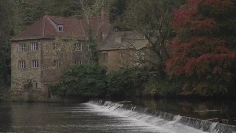 A static medium shot focusing on the historic stone Fulling Mill Видео 326420937