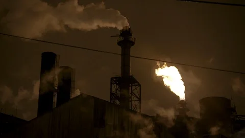 Static medium shot of smoke and gas stacks on factory at night Stock Footage 89945455