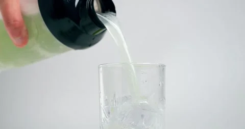Static medium slow motion shot from a shaker filled with green apple whey Stock Footage 250249433