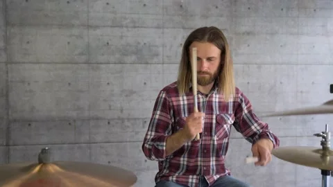 Static MEDIUM Young Inspired Bearded Man At Home  Playing Drums Stock Footage 155554436