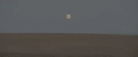 Static Mid Shot of Suffolk Shingle Beach at Dusk with Rising Moon Stock-Footage 320114666