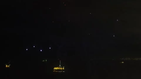 Static night view of ocean with fireworks display, illuminated offshore Video stock 327392815