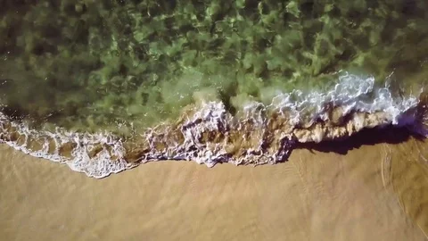 Static Overhead Shot Of Clear Water Waves Gently Crashing On A Sandy Beach Stock Footage 83961051