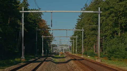 Static POV View Between Railway Tracks With Overhead Catenary Under Clear Blue Stock-Footage 345286123