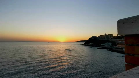 Static real-time footage of a sunset over the calm sea with the sun reflected on Stock Footage 143572234