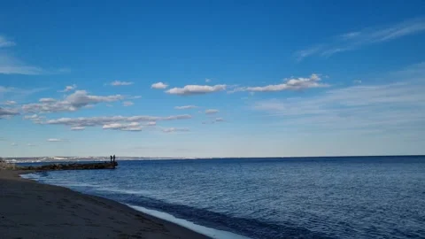 Static sea view with distant ship and bright blue sky Stock Footage 320455402