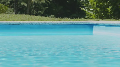 Static, seamless looping background video of a clear blue swimming pool Stock Footage 338323758