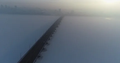 Static shooting from the drone of a road bridge in the fog with cars moving alon Stock Footage 103489309