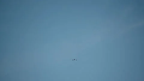 Static shot of airplane flying away against blue sky Stock Footage 161245167