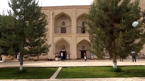 Static shot of ancient madrasah facade with arched niches in Bukhara Stock Footage 335954134