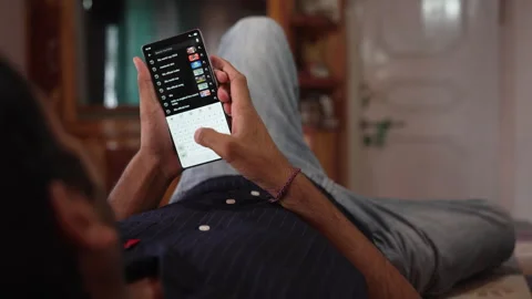 Static Shot of and Indian Man Searching FIFA World Cup 2026 on Smartphone. Stock Footage 338298678