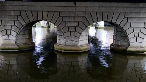 Static shot of arches under river bridge Stock Footage 171799435