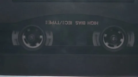 Static shot of an audio cassette tape in motion Stock Footage 272482943