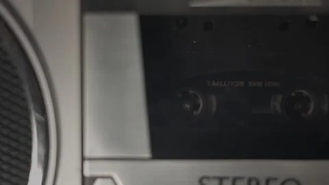 Static shot of an audio cassette tape in motion Stock Footage 272483169
