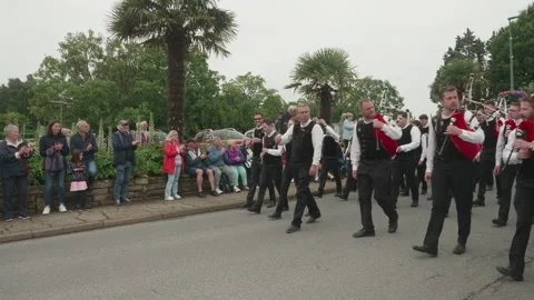 Static shot of bagpipers marching in Breton festival parade with spectators Video stock 341314223