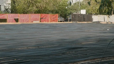 Static shot of balck plastic tubes on ground covered with concrete. Future Video stock 120987085