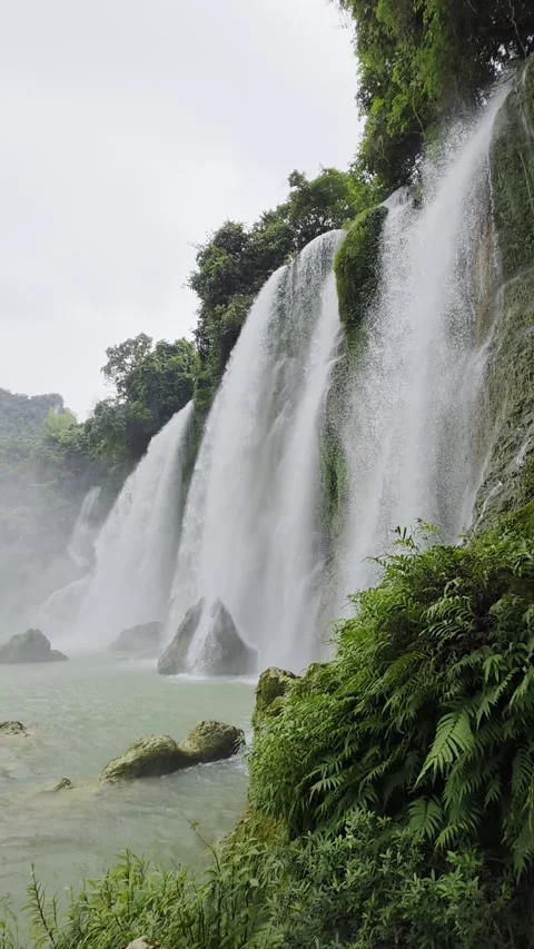 Static shot of Ban Gioc waterfall with ferns and mist, Vietnam, vertical Stock Footage 346760348