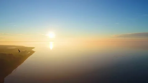 Static shot on birds flying in front of pretty sunset Stock Footage 155463185