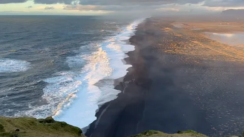 Static shot of black sand beach and Atlantic ocean at sunset from Dyrholaey.. Stock Footage 327683735