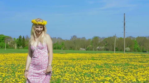 Static shot of blond lady and dandelion field. Stock Footage 49821318