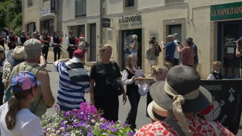 Static shot of Breton bagpipe band performing at cherry festival in La Foret Stock Footage 342023228