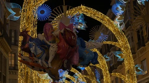 Static shot of a bunch of balloons hold under night Christmas illumination Stock Footage 121111818