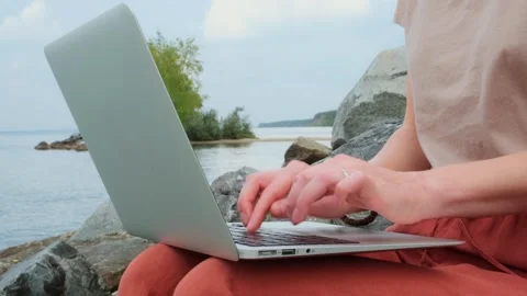 Static shot close-up woman's hands typing on a laptop keyboard outdoors. Stock Footage 252665476