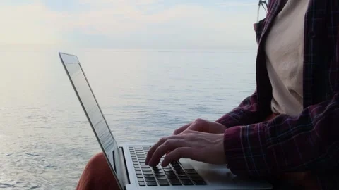 Static shot close-up woman's hands typing on a laptop keyboard outdoors. Stock Footage 259153481