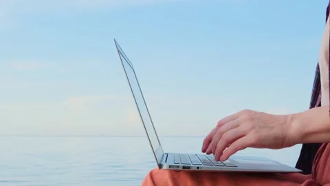 Static shot close-up woman's hands typing on a laptop keyboard outdoors. Stock Footage 266486275