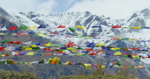 Static shot of colorful Buddhist prayer flags fluttering in a cold Himalayan Stock Footage 336341010