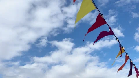Static shot of coloured flags above fluttering in the breeze with space for text Video stock 335448531