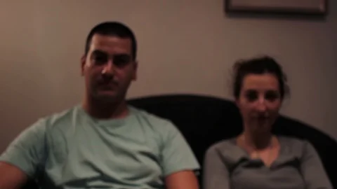 A static shot on a couple with focus on the remote control   Stock Footage 85570974