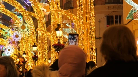 Static shot of a crowd watching night Christmas illumination in the street. Stock Footage 122511193
