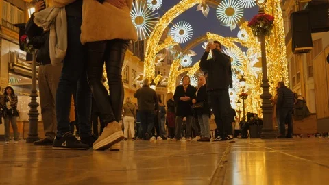 Static shot of a crowd watching night Christmas illumination in the street. Stock Footage 122560861