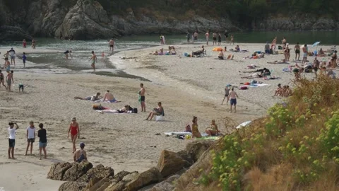 Static shot of crowded beach on sunny summer day, Rospico Beach Brittany France Stock Footage 341314193