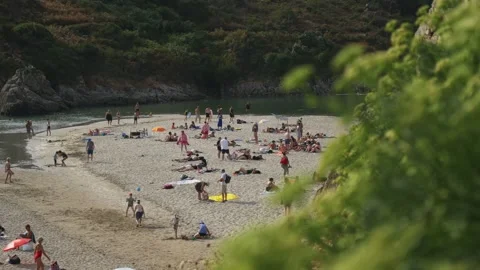 Static shot of crowded beach on sunny summer day, Brittany France Stock Footage 341314479