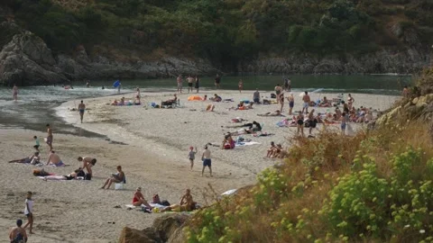 Static shot of crowded beach with turquoise water, rocky cliffs, summer Stock Footage 341314228