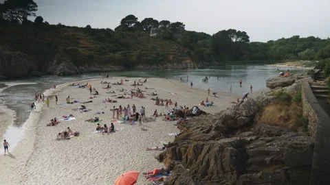 Static shot of crowded Rospico Beach during sunny summer day in Nevez Brittany Stock Footage 341314210