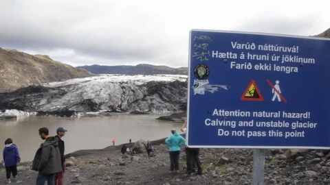 Static shot of Danger Sign w/ Solheimajokull glacier in Background Stock Footage 103684568