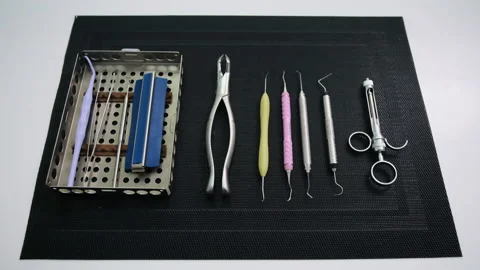 Static shot of Dentist tools on black mat. Teethcare, dental health concept Stock Footage 131483685