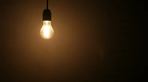 Static shot of dimmable light bulb turning on Stock Footage 20646836
