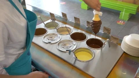 Static shot dipping ice cream cone in melted chocolate, summer mood 库存影片 295548143