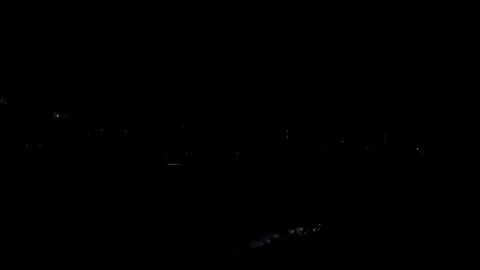Static shot of distant cityscape with illuminated buildings at night Stock Footage 346622470