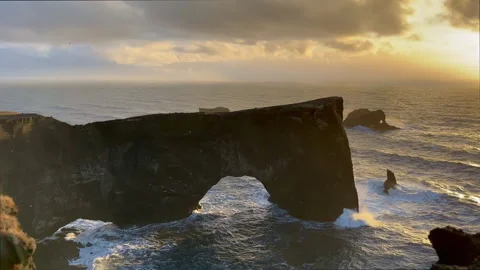 Static shot of Dyrholaey stone arch and sea cliffs at sunset in winter, Sou.. Stock Footage 327683742