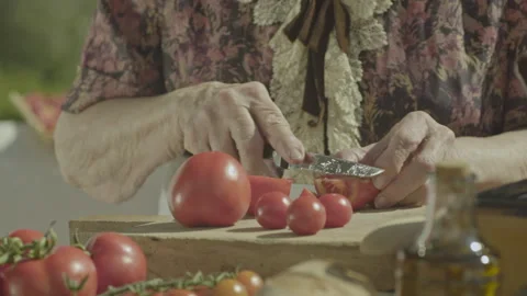 Static Shot Of Elderly Woman Hands Slicing Ripe Tomatoes On Board Stock Footage 344727848