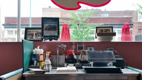 Static shot of empty diner counter with coffee urns and window view Stock Footage 336352120